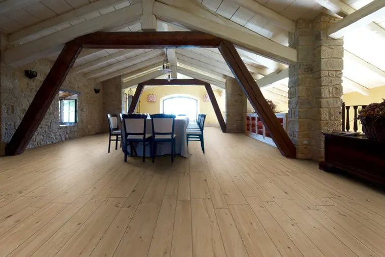 Dachgeschoss mit Holzbalken und hellem Boden in Holzoptik